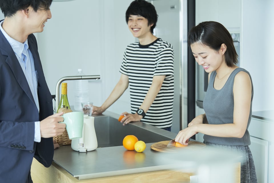 シェアハウスのキッチンで談笑する入居者たち