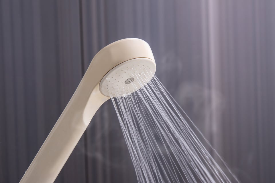 シャワーヘッドからお湯が出ている様子