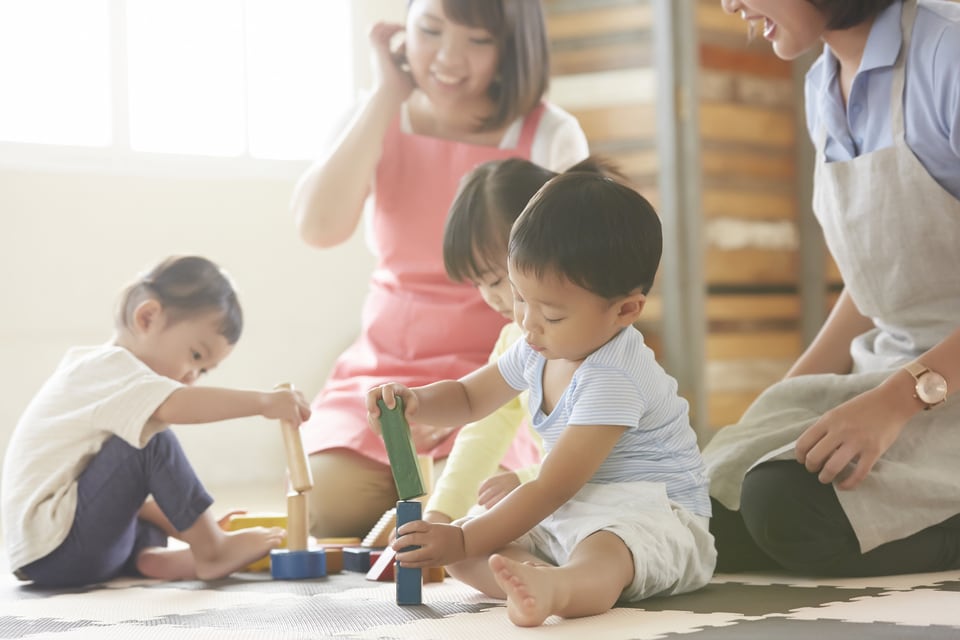 託児所で積み木を使って遊ぶ子どもたち