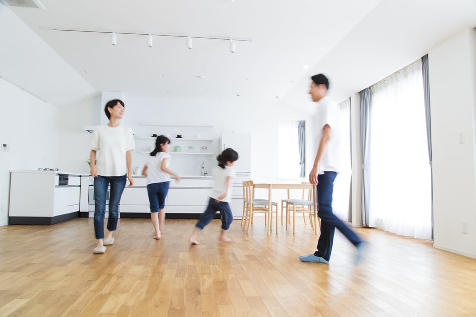 防振フローリングのリビングで遊ぶ家族