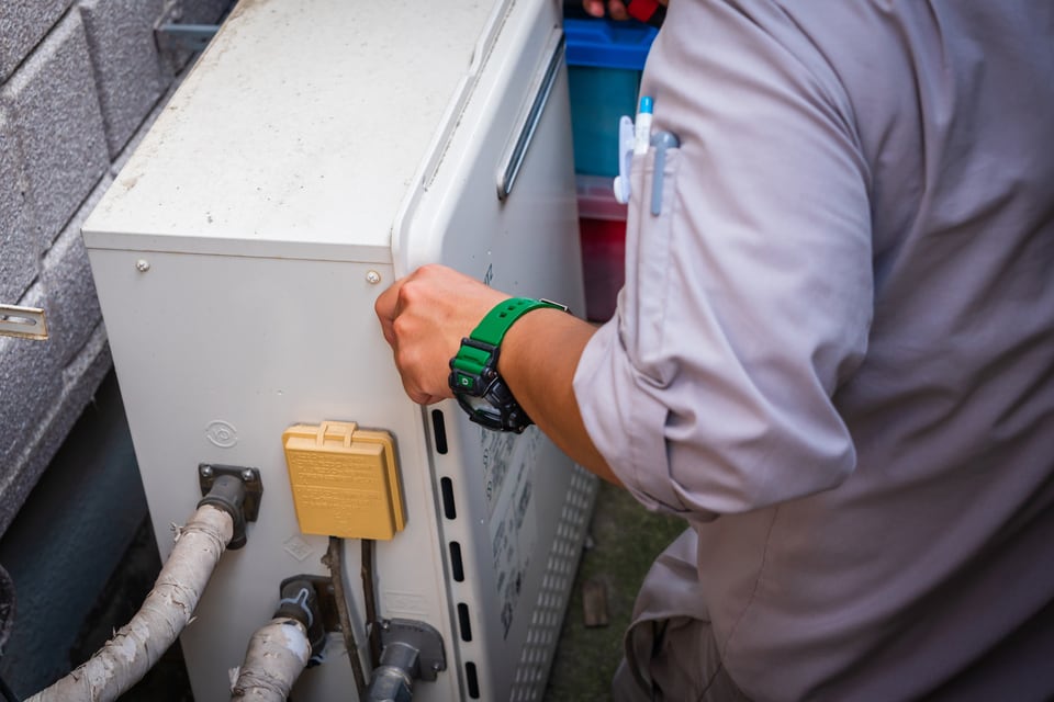 貯湯式ボイラーを点検する男性作業員