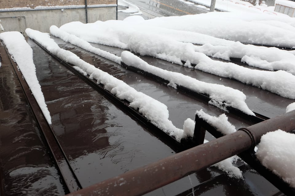 温めた不凍液を排水管に通して雪を解かす融雪屋根